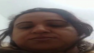 Playful Desi woman lies on bed touching nice tits and XXX flower