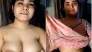 Indian slut sits in front of camera happily baring saggy XXX boobs