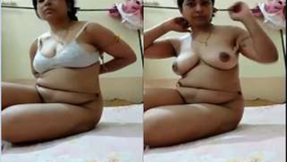 Desi woman debunks XXX breasts lying down on bed in porn video