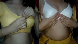 Desi female slowly removes her top and bra exposing XXX boobs on camera