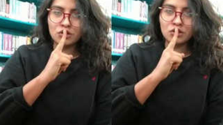 Desi sex student pulls T-shirt up to demonstrate XXX breasts in a library