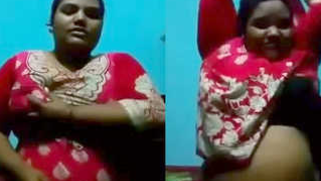 Mature Desi in a red sari exposes her big sex parts in a XXX show