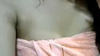 Female covers her XXX tits with a towel but masturbates sex hole