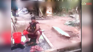 Indian MILF sits outdoors and washes erogenous zones flashing boobs