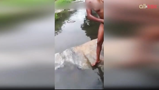 Lewd amateur Desi aunty flashing her nice big tits while bathing outdoor