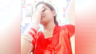 Young woman smiles on camera and changes clothes in sex video show