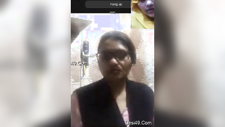 XXX-looking aunty with glasses shows off her naked titties on camera