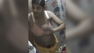 Attractive Desi girl changes in bathroom without knowing about cam