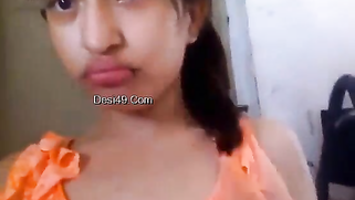 Indian babe in orange takes clothes off to flaunt boobs and buttocks
