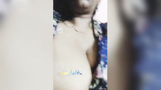 Desi woman in floral robe teases lover demonstrating big breasts