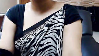 Big-boobied Desi in carnival mask spreads legs to touch pussy