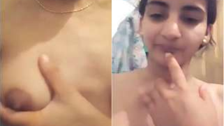 Attractive Indian girl checks out breast firmness on the camera