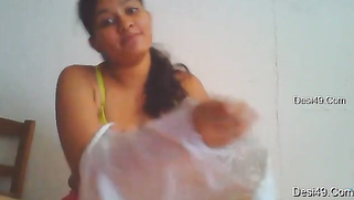 Cute possessor of natural Desi tits puts on clothes in front of camera