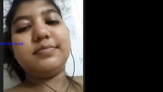 Cheeky Indian girl sticks her tongue out besides showing tits