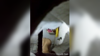 There is a hole in the bathroom and perv films the naked Indian