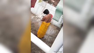 MILF dries hair and body outdoors being filmed by an Indian perv