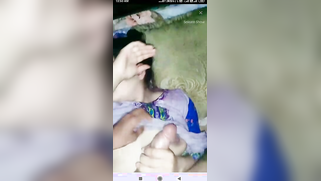 Girl holds penis in hand and hides face from camera in Indian sex clip