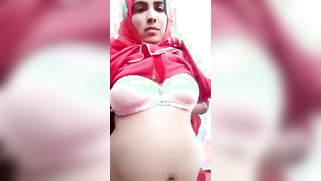 Naughty Desi woman in hijab showing perky tits and pussy on camera