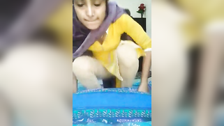 Indian coed in yellow dress turns on the camera and masturbates