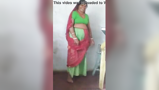Joyful Desi woman lifts green dress to demonstrate hairy vagina