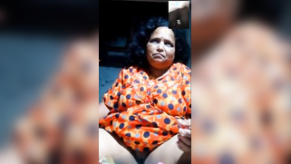 Mature chubby camgirl in orange sari dives finger in pussy in XXX show