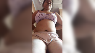 Chubby Tamil aunty with saggy XXX melons actively rubs own snatch